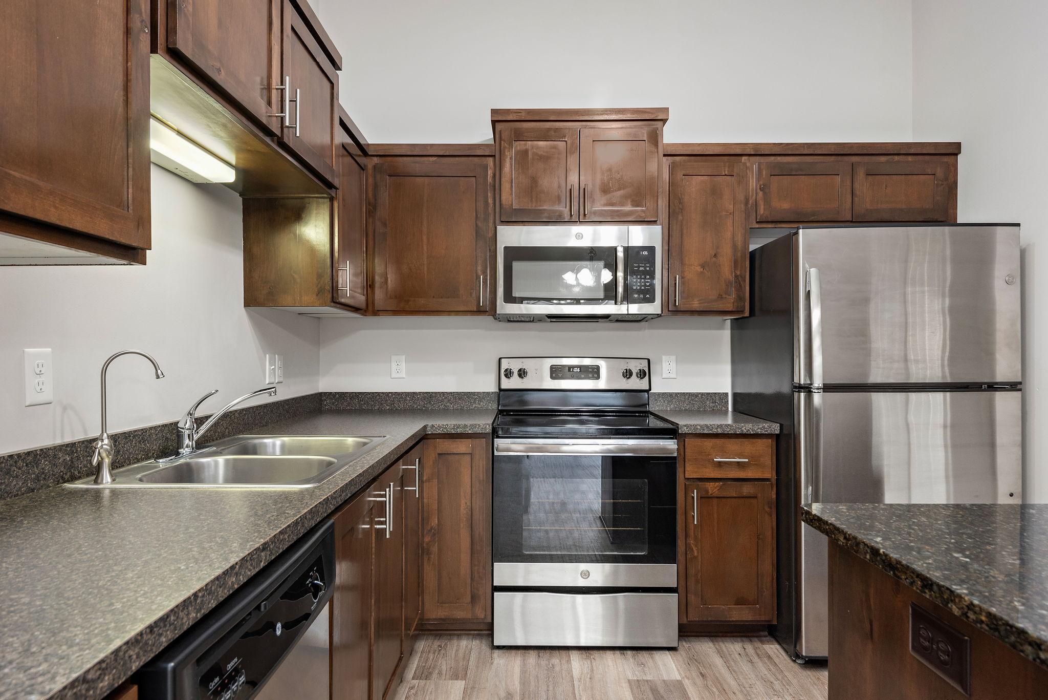 Nice Kitchen with Granite Center Island, Stainless Steel appliances and Open to Dining Room and Living Room