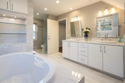 Primary owners suite full bathroom - heated floors, skylights, double sink vanity, separate tub and steam shower.