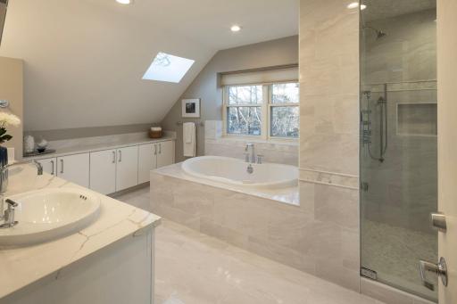 Primary owners suite full bathroom - heated floors, skylights, double sink vanity, separate tub and steam shower.