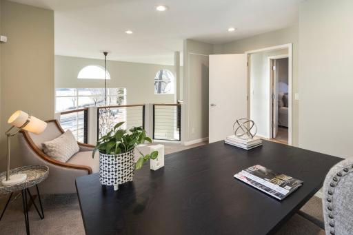 Second level office with lookout over living room offers sight lines to lake views.