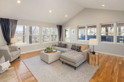 Main level family room offers access to screened porch.