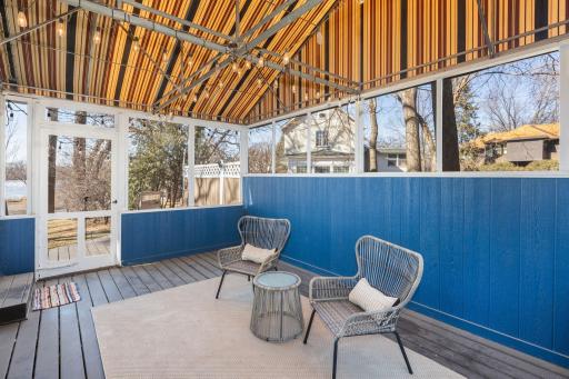 Screened porch with lake views and access to backyard private patio.