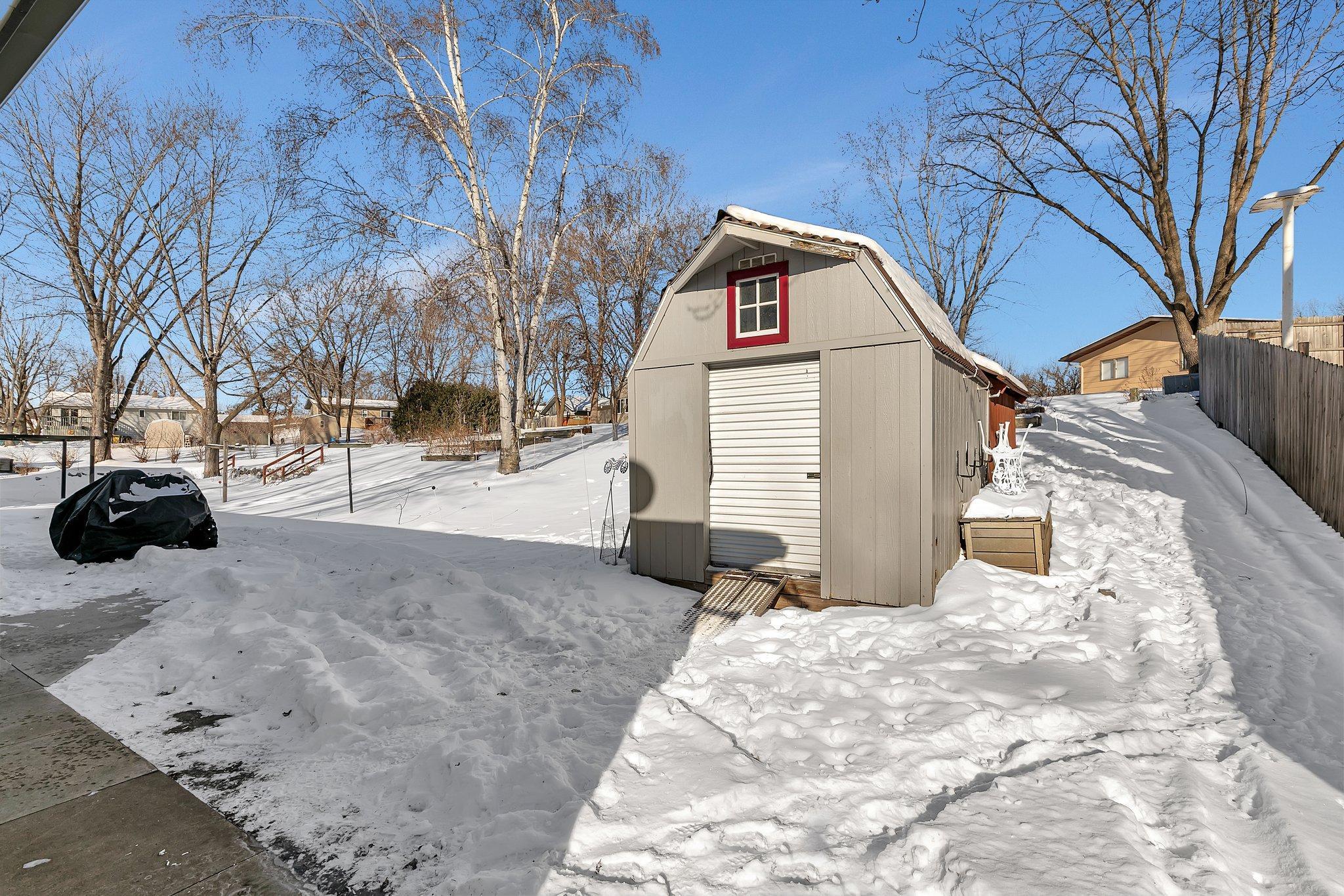 12x10 storage shed with large covered area behind.