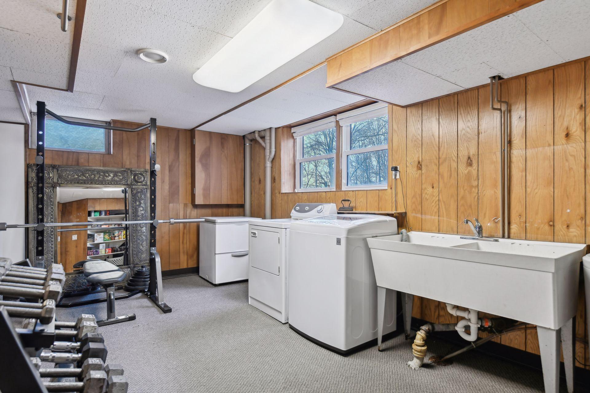 Laundry room in lower level with large wink and room for a workshop or crafting area.