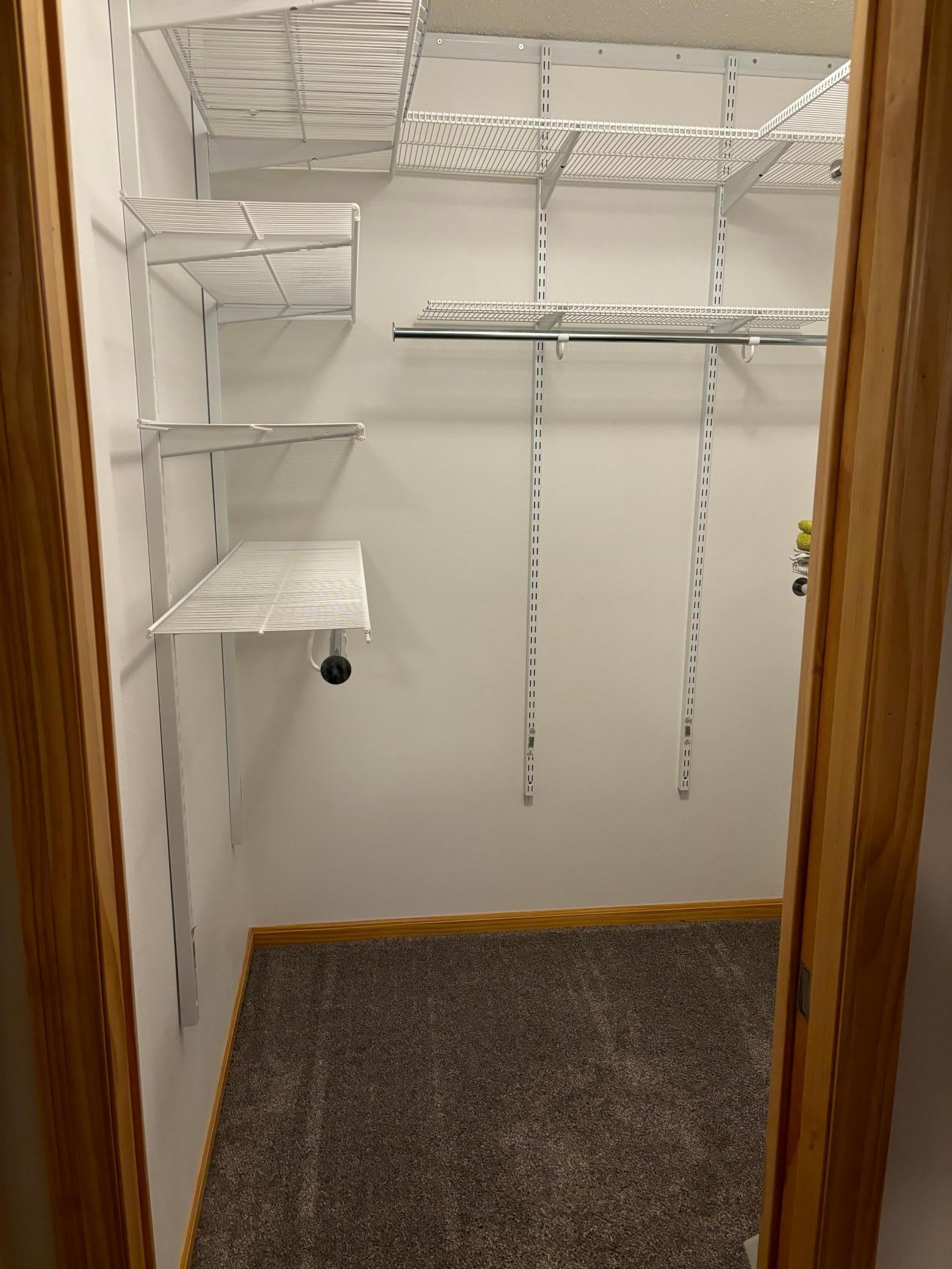 Walk in closet in the primary bedroom.