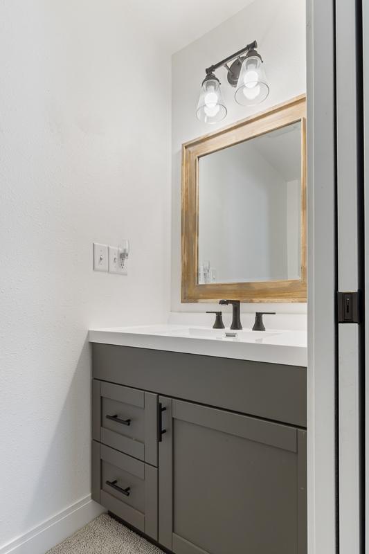 Primary bedroom features a convenient half bath