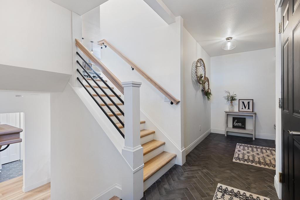 Step inside to a stunning foyer - beautiful chevron mosaic tiles enhance this entryway with a sleek and modern design - foreshadowing what's to come!