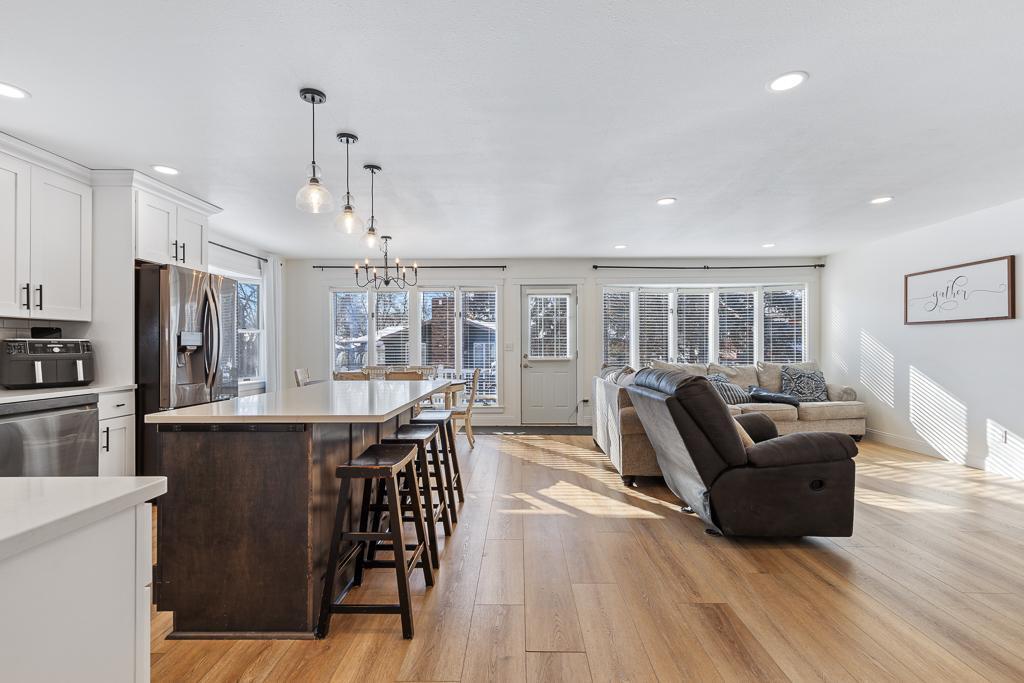 Some of the best things about this space! Open layout, back deck access, and a whole wall of windows providing natural light.
