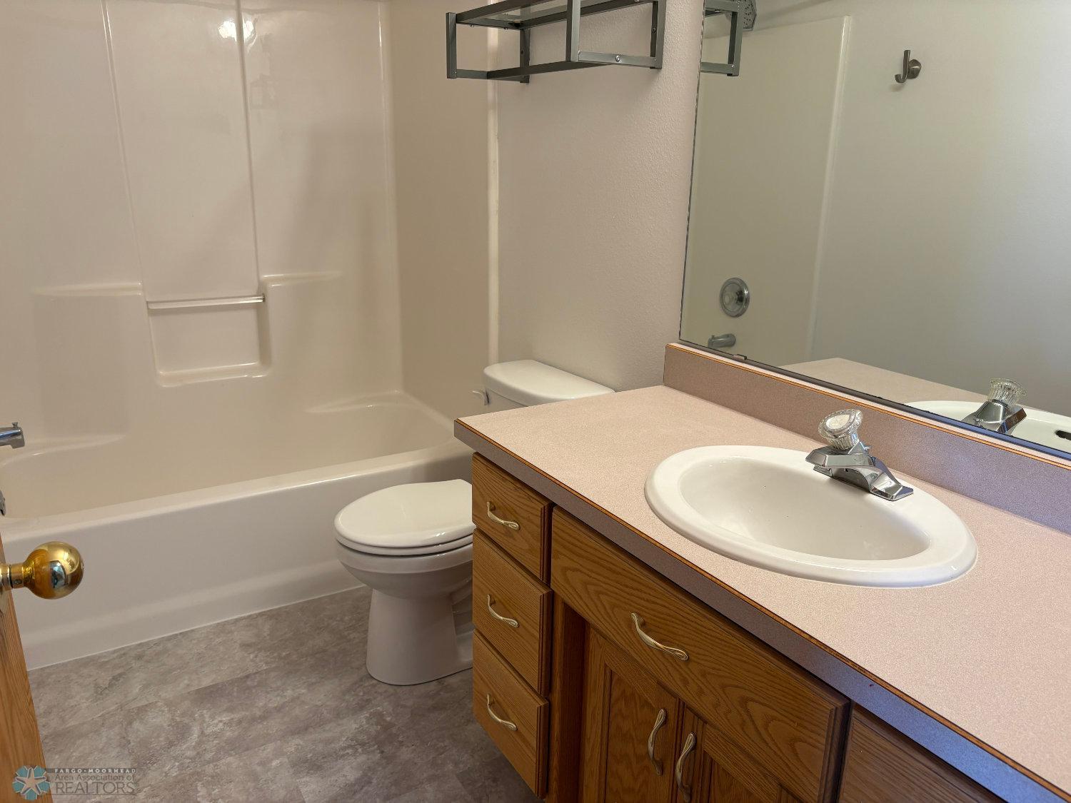Lower level full bath with new vinyl flooring and toilet February 2025-view 1.jpg