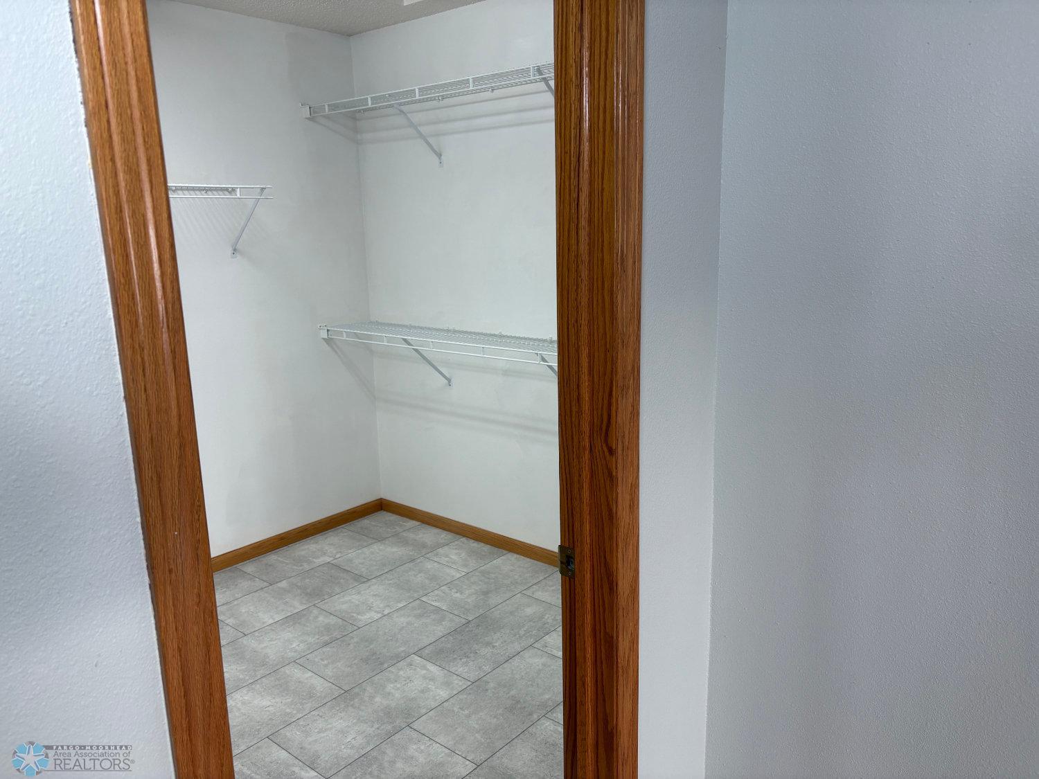 Master bedroom large walk-in closet with new vinyl flooring 2023-view 1.jpg