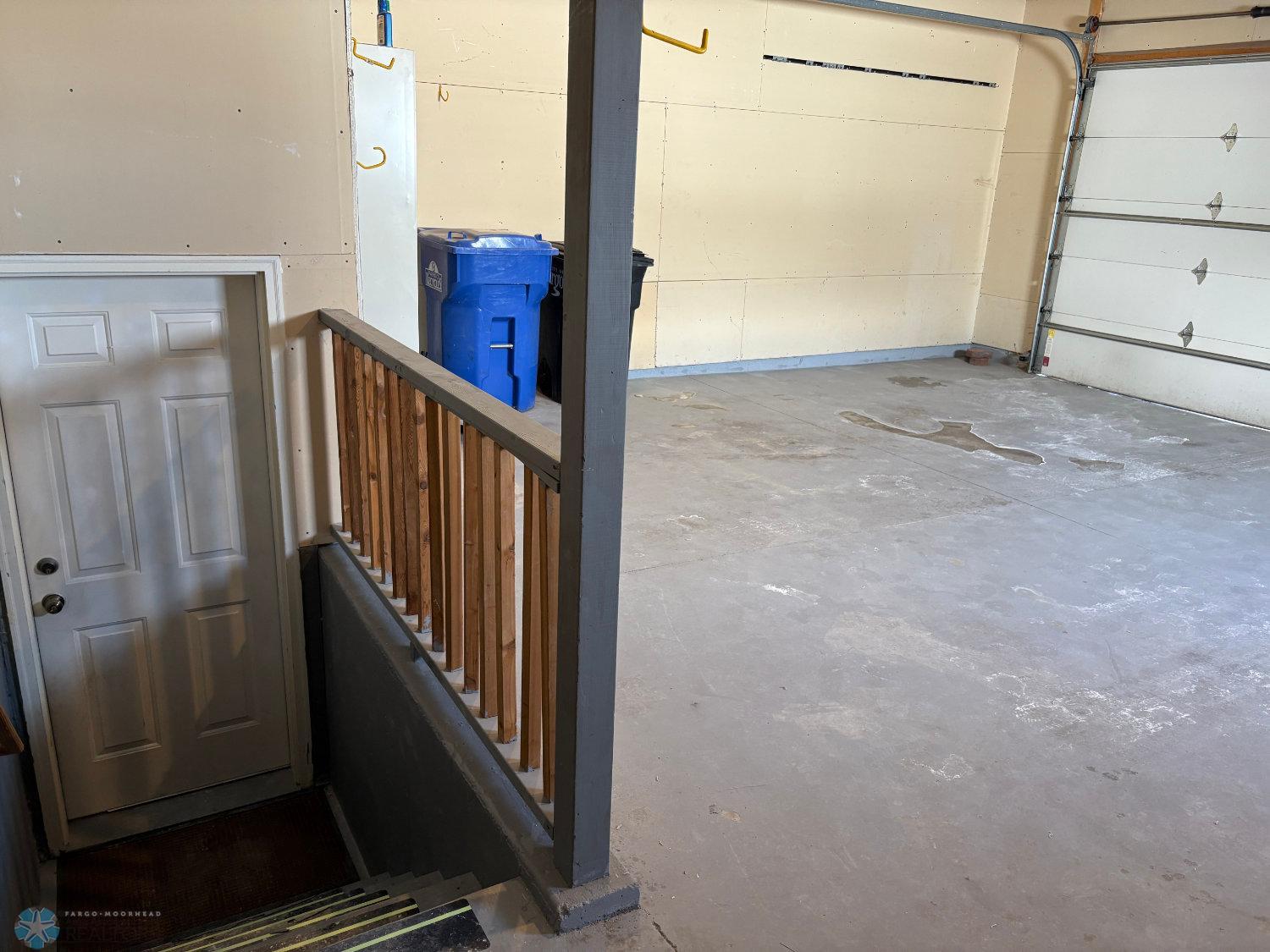 Large double garage has entry stairs to the lower level.jpg