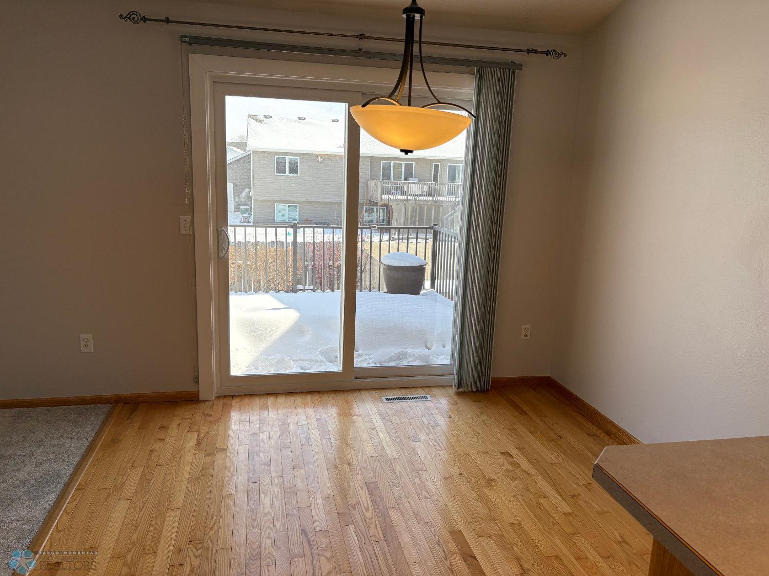 Dining area with 3:4 inch solid oak floor and vaulted ceiling-view from kitchen.jpg
