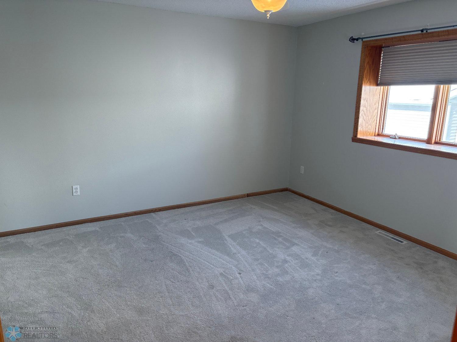 Master bedroom with new carpeting 2023 view from entry door.jpg