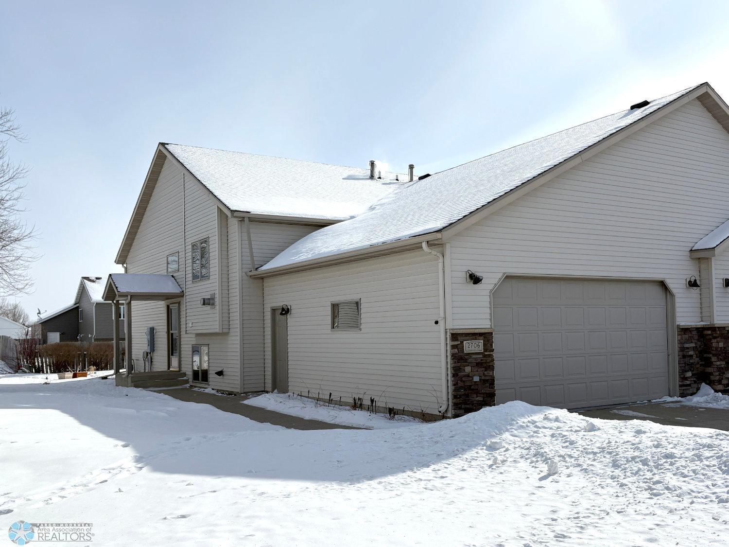 Exterior-steel sided twinhome with large double garage.jpg