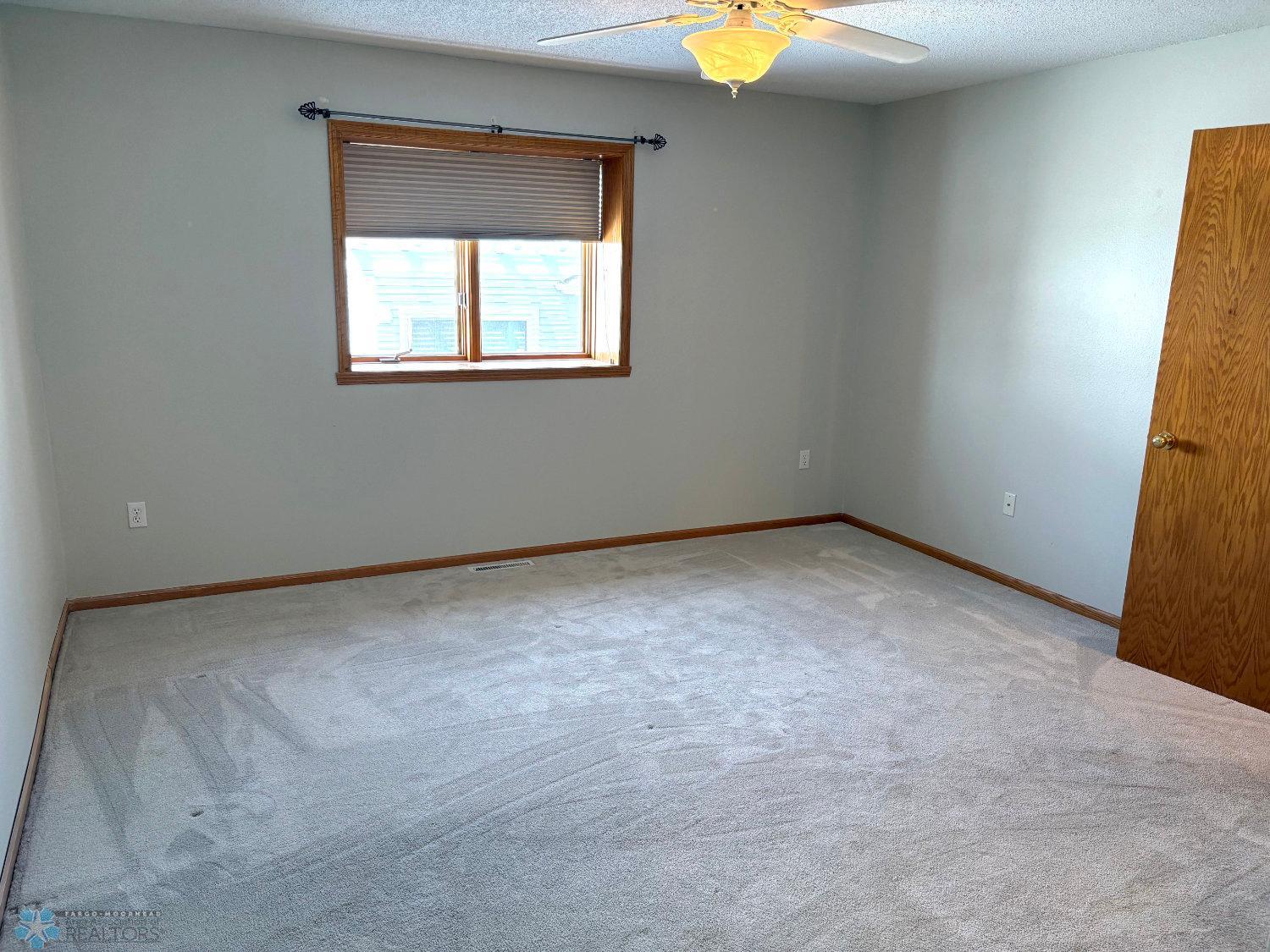 Master bedroom with new carpeting 2023 view from walk-in closet.jpg