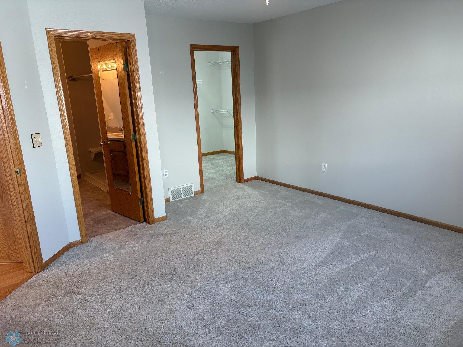 Master bedroom with new carpeting 2023 view to Hollywood bath and walk-in closet.jpg