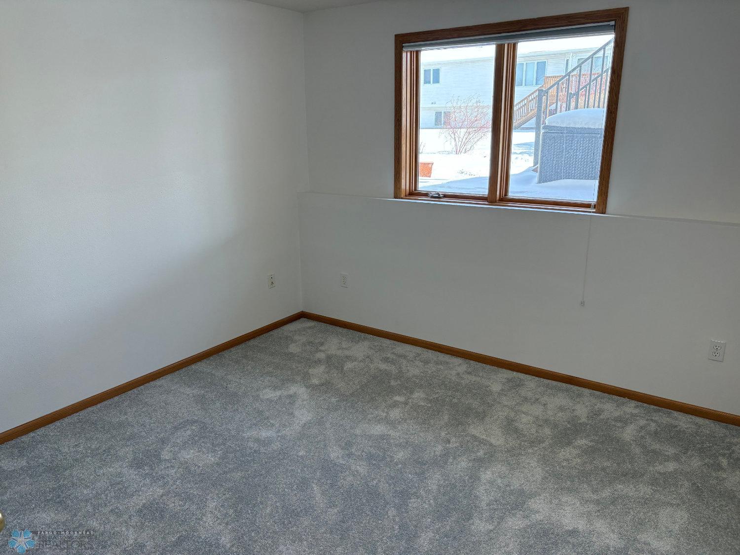 Bedroom 3 on lower level with new carpet February 2025-view 1.jpg