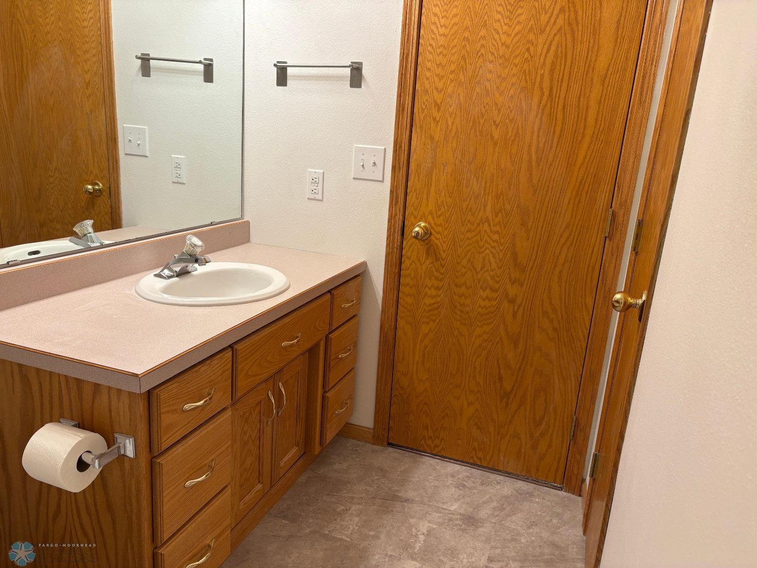 Lower level full bath with new vinyl flooring and toilet February 2025-view 2.jpg