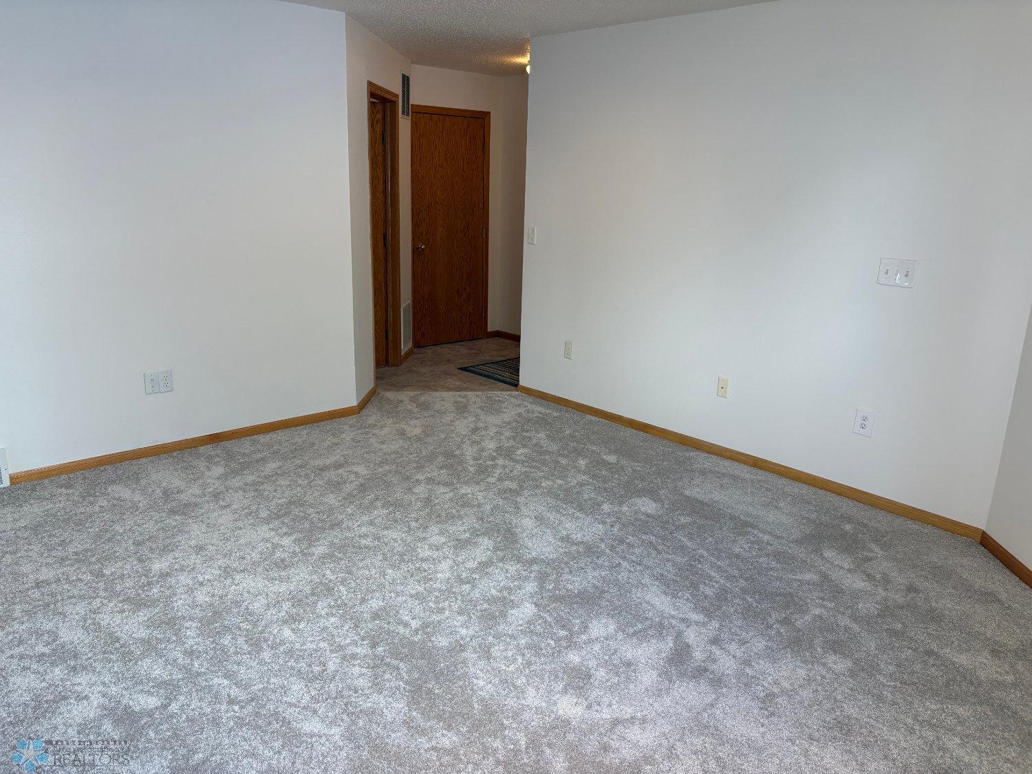Lower level family room with new carpet February 2025 and has rough-in for gas fireplace-view 3.jpg