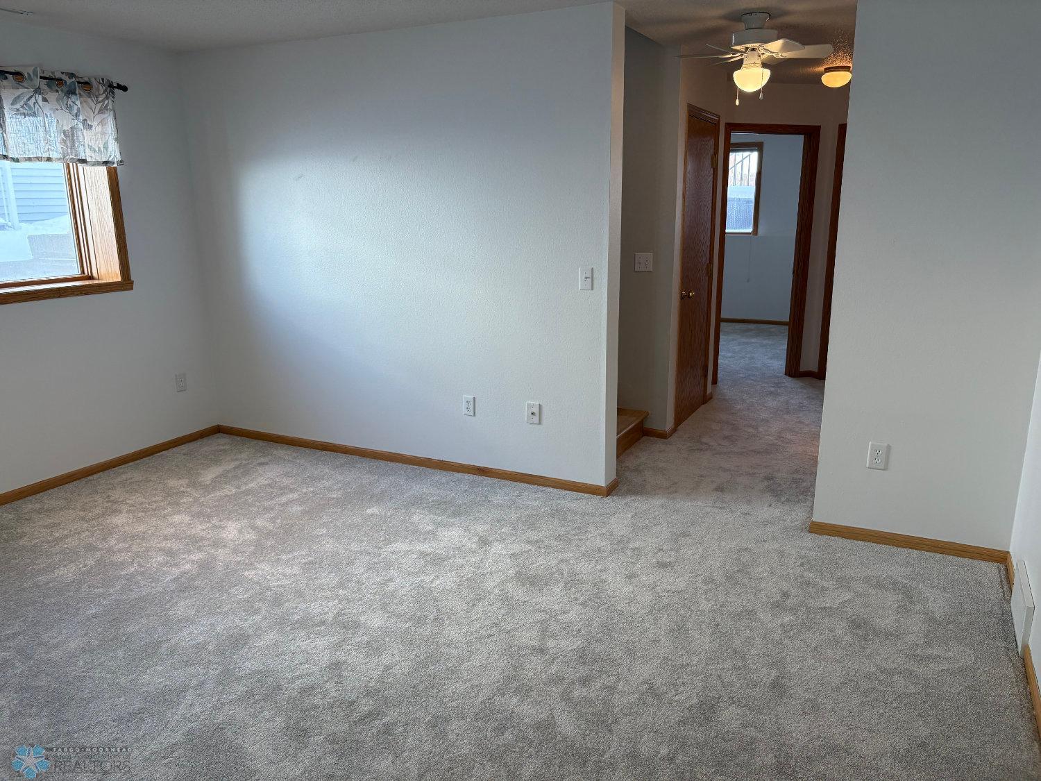 Lower level family room with new carpet February 2025 and has rough-in for gas fireplace-view 4.jpg