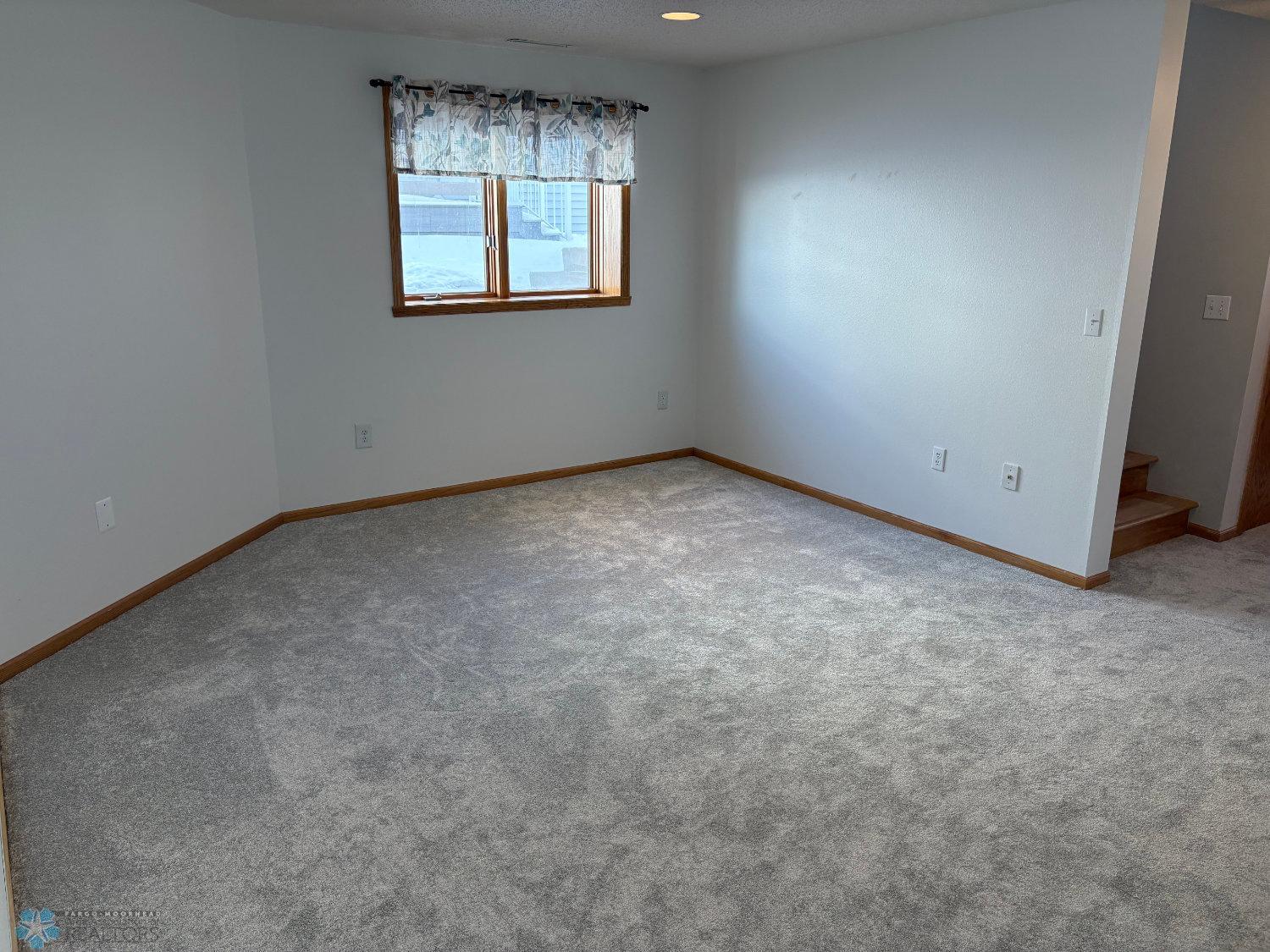 Lower level family room with new carpet February 2025 and has rough-in for gas fireplace-view 1.jpg