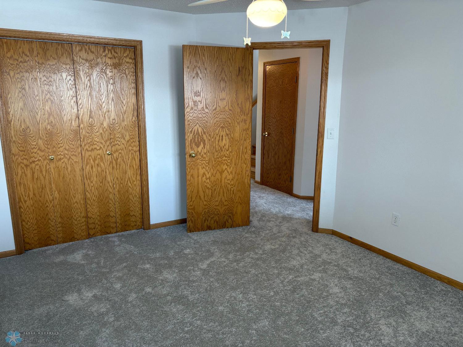 Bedroom 2 on lower level with new carpet February 2025-view 2.jpg