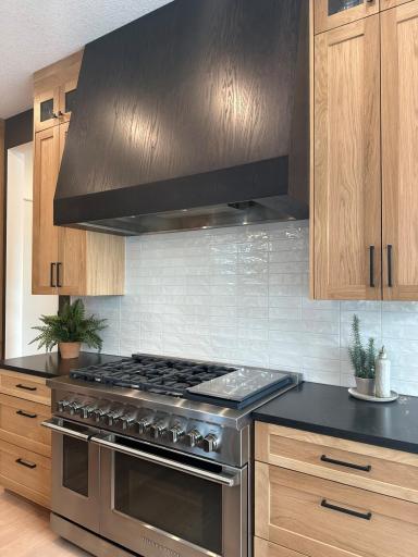True Gourmet kitchen with 60" hood and 48" Fisher and Paykel