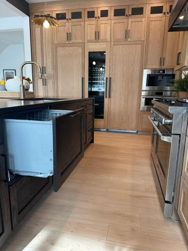 Gourmet kitchen features Fisher and Paykel dishwasher drawers with paneled front