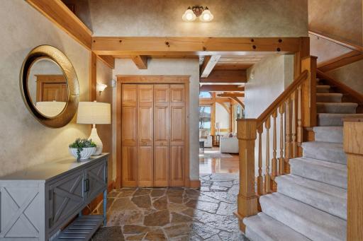 Enjoy a tasteful combination of stone and and timber post and beam construction