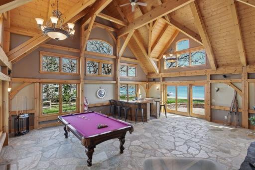 Main level amusement room and wet bar open to one of the 3 patio areas