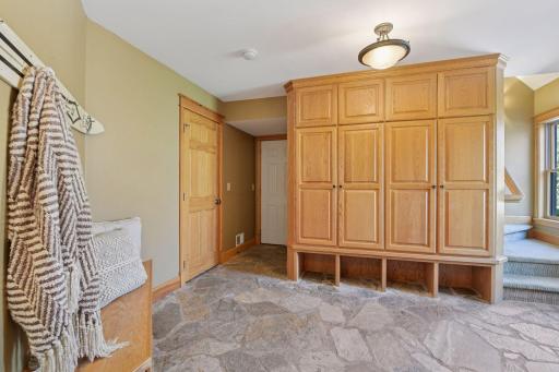 Mudroom area with staircase to the bonus space