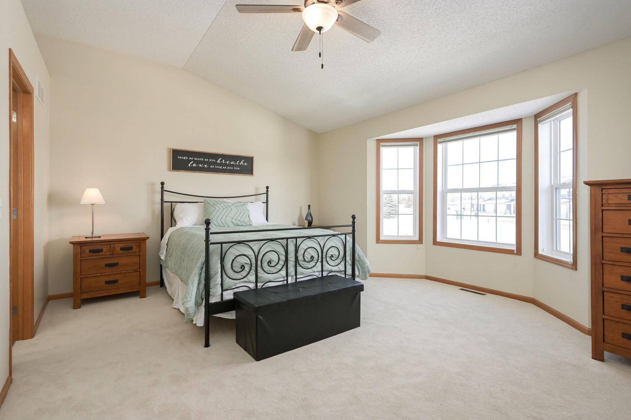 Large primary bedroom with bay window and vaulted ceilings to give it an even bigger feel.