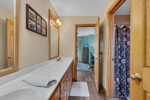 Tub and stool tucked behind the pocket door for an easily shared space while accommodating privacy