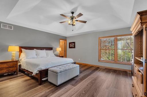 A stunning private primary suite awaits you, with it's soaring trayed ceiling, generous floor space, and an exquisite primary bath with soaking tub, separate shower, huge walk-in closet and private laundry ~ simply luxurious!