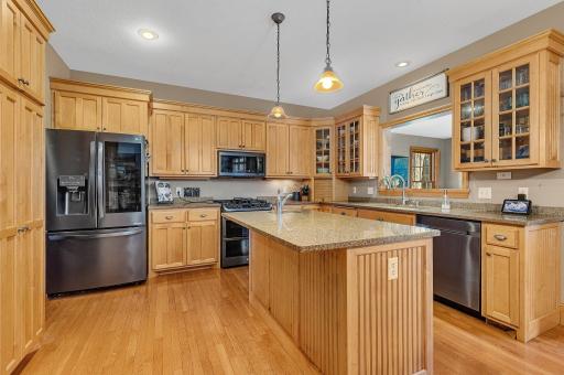 Gorgeous granite tops, huge island & impressive appliances in the well-equipped kitchen