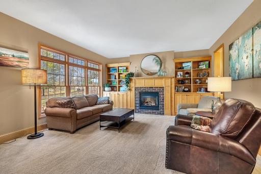 The cozy family room has an extraordinary view and features a cozy fireplace flankced by built-ins
