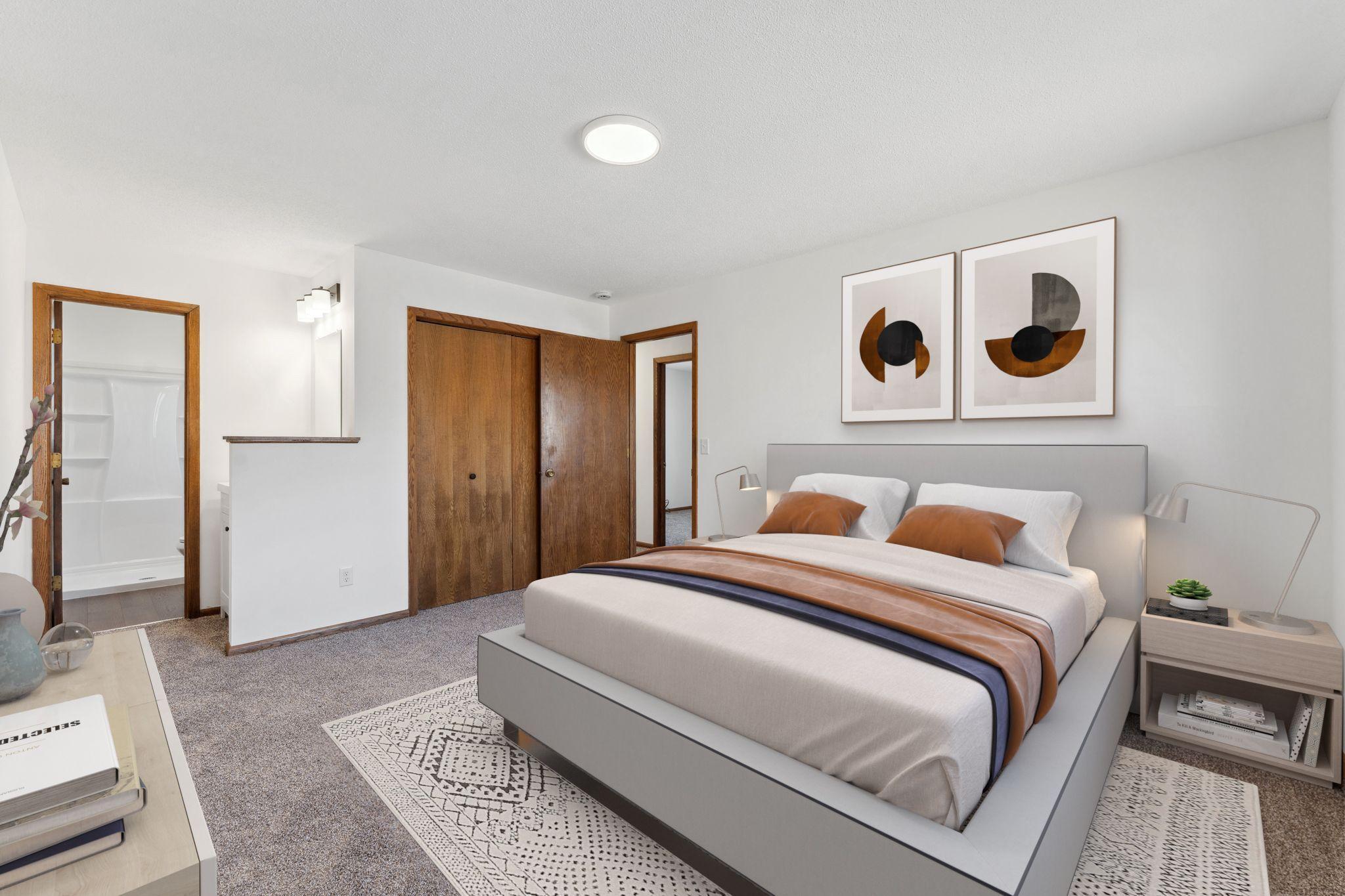 Virtually staged primary bedroom. New carpet, paint, lighting and refreshed 3/4 bathroom with new shower liner and vanity.