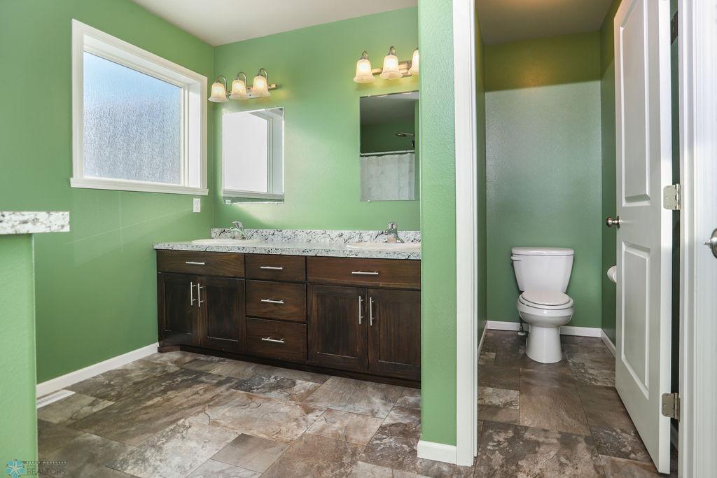 Primary bathroom features double sinks and water closet