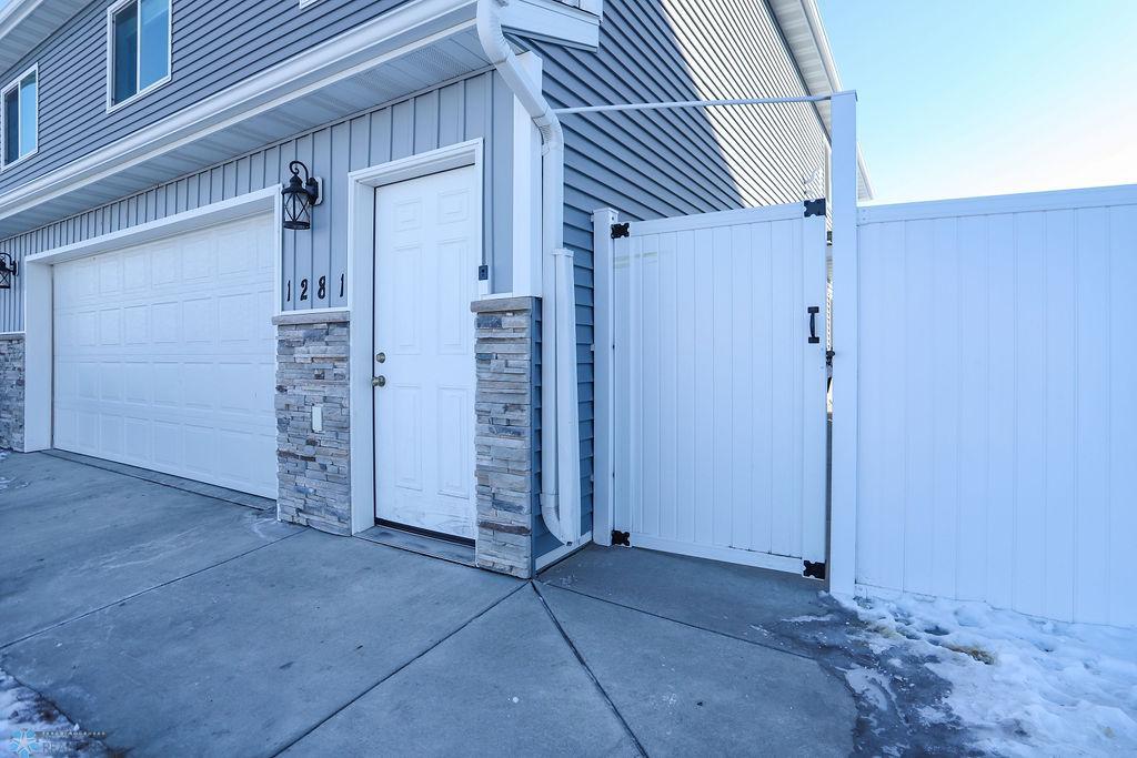 Entry door leads to garage, gate leads to side entry into house