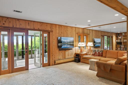 The patio doors open out to the screen porch beneath the deck.