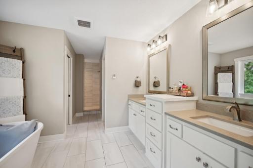 Spa-like features: heated marble flooring, a soothing jacuzzi tub, a spacious walk-in shower