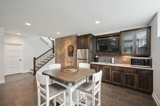 The lower level of the home is an entertainment haven, complete with full wet bar