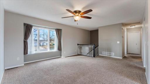 Living Room features ceiling fan and window overlooking front yard.