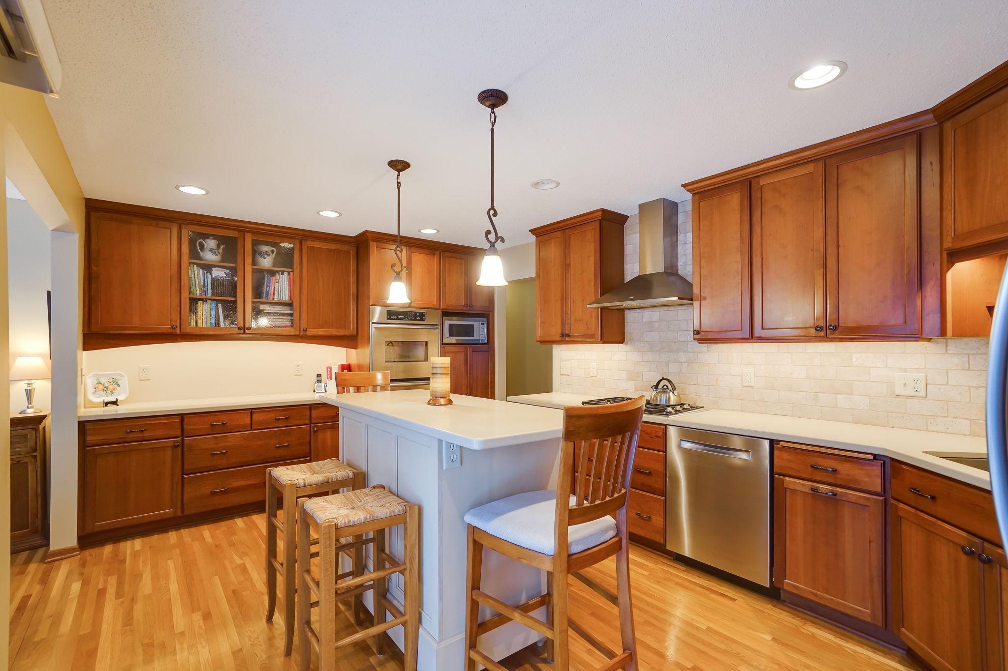 Remodeled kitchen with cherry cabinets, some glass fronts