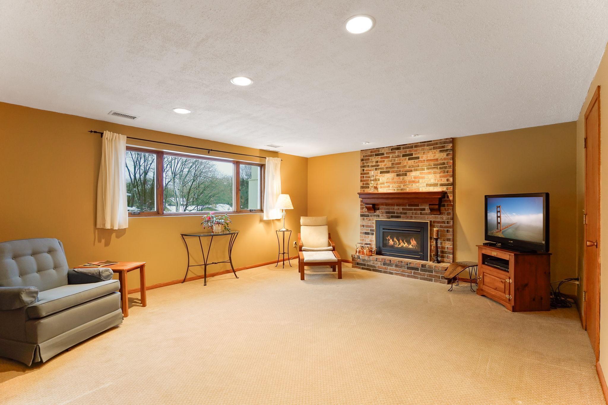 Cozy family room with gas fireplace, daylight windows