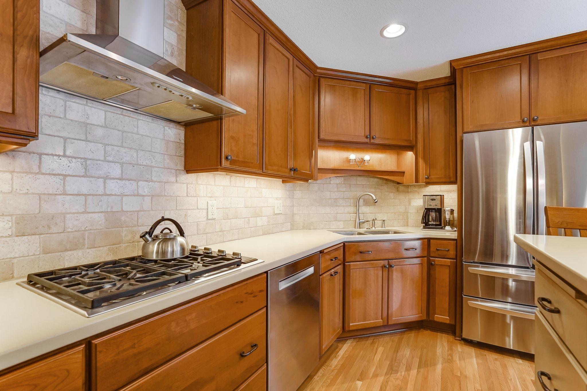 Beautiful cherry cabinets, gas cooktop, corian counters