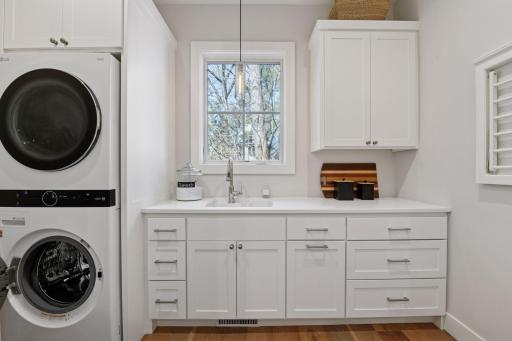 From the garage will notice a power room on your right and this laundry room on your left. The oak floors run throughout the main floor with the exception of the primary suite.