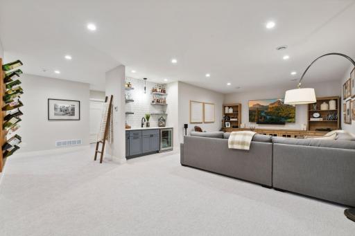 Lower level family room with wet bar and available gas line to add a fireplace. So much space you could easily fit a game table to the area.