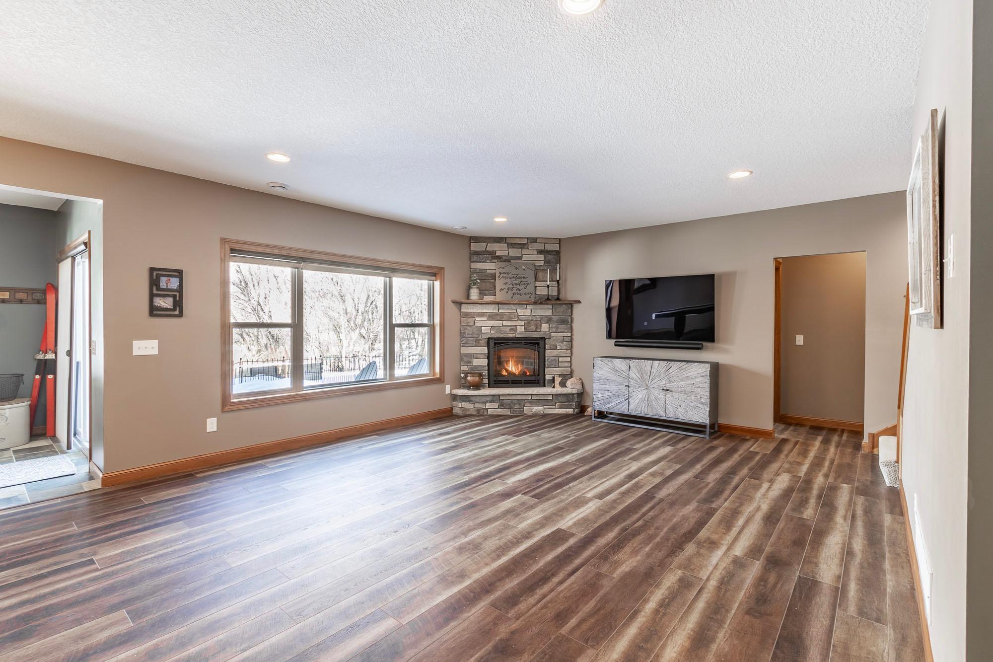 Lower level family room with luxury vinyl plank flooring.