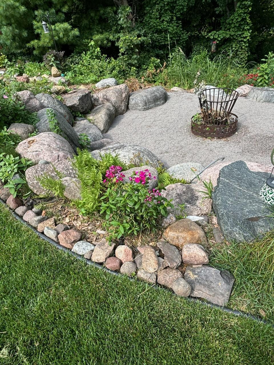 Tiered yard with landscaped fire pit.